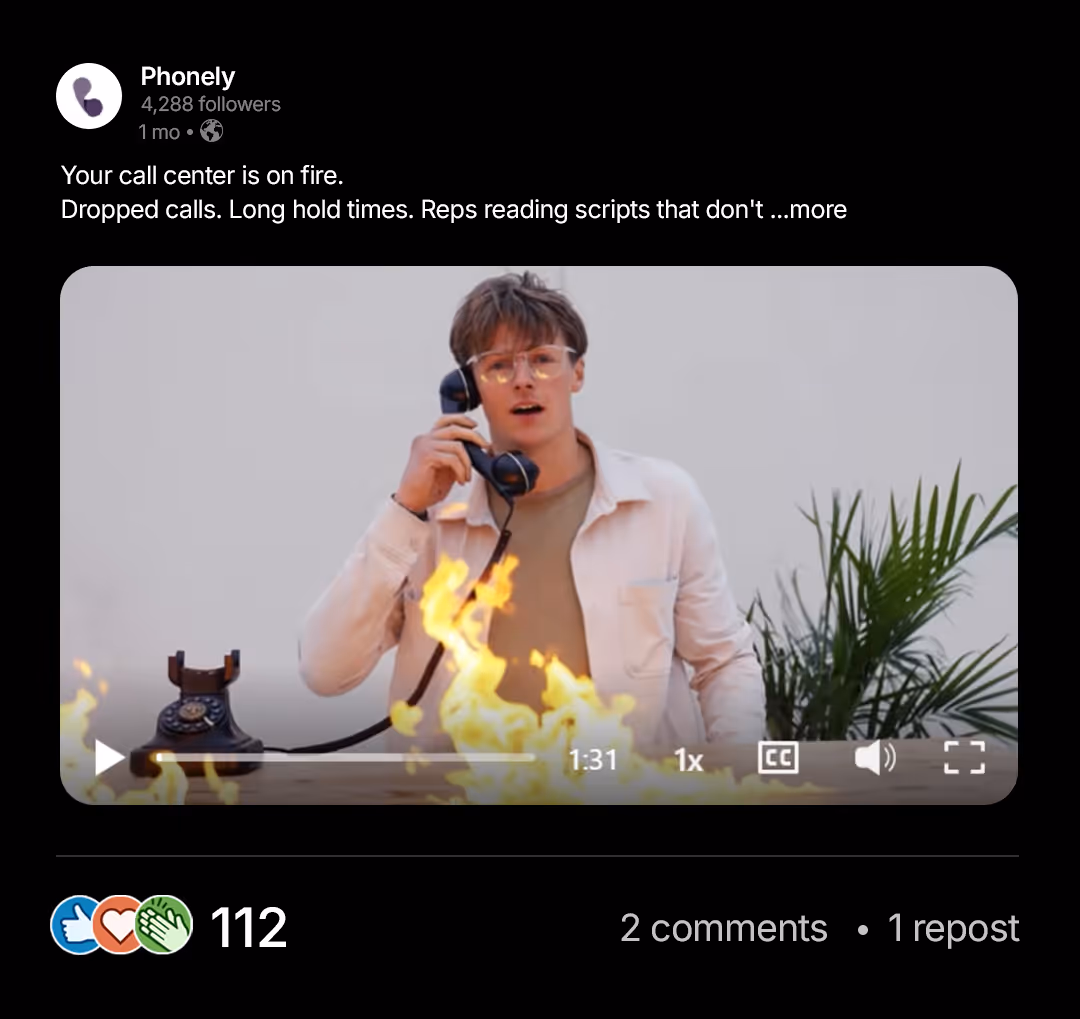 Man holding phone receiver with fire in front of him and a plant in the background.